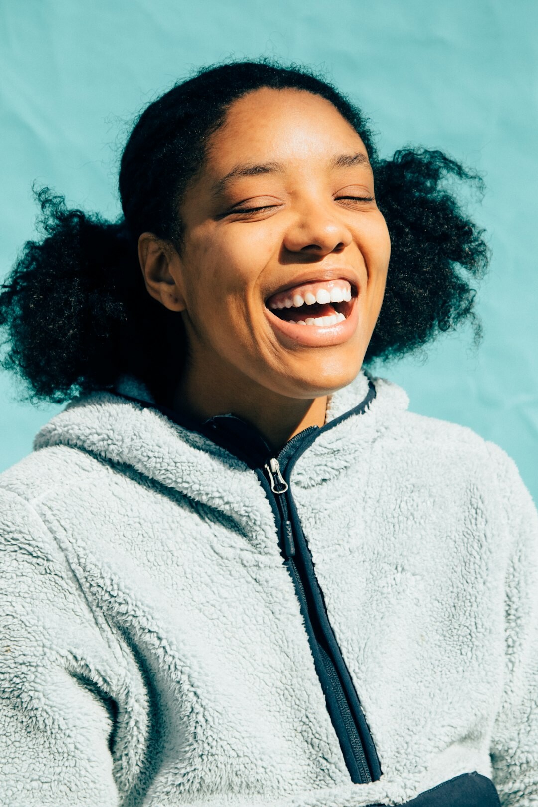 Young African-European woman laughing during a business meeting